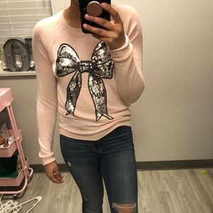 Pink sweater with silver sequin bow